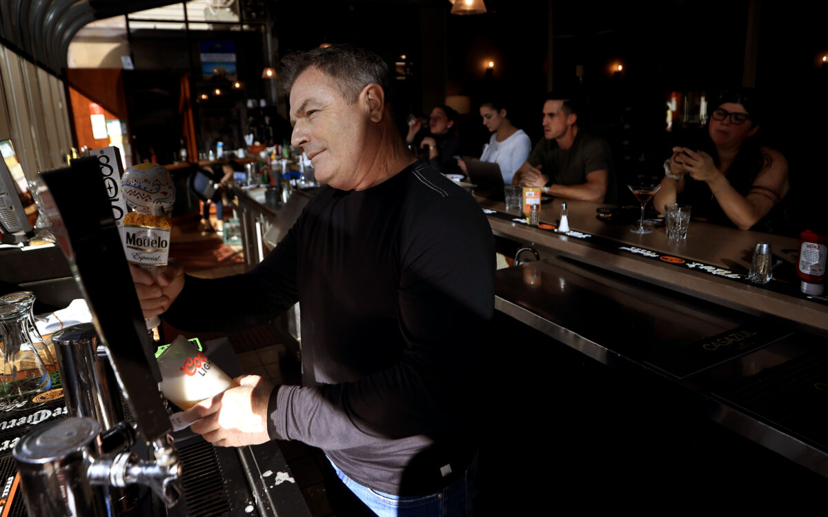 Jim Goff, owner of Sky Lounge Steak House & Sushi Bar at Charles M. Schulz-Sonoma County Airport, looks out at travelers passing by Wednesday, Dec. 28, in Santa Rosa. After a 15-year run, the restaurant will be closing Friday, Dec. 30. (Kent Porter / The Press Democrat) 2022