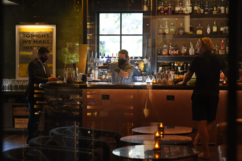 Bartender Levi Ellsworth, center, preparing cocktails in the bar area at Layla restaurant at MacArthur Place Hotel and Spa in Sonoma, Calif. on Thursday, May 6, 2021. (Erik Castro/for The Press Democrat)