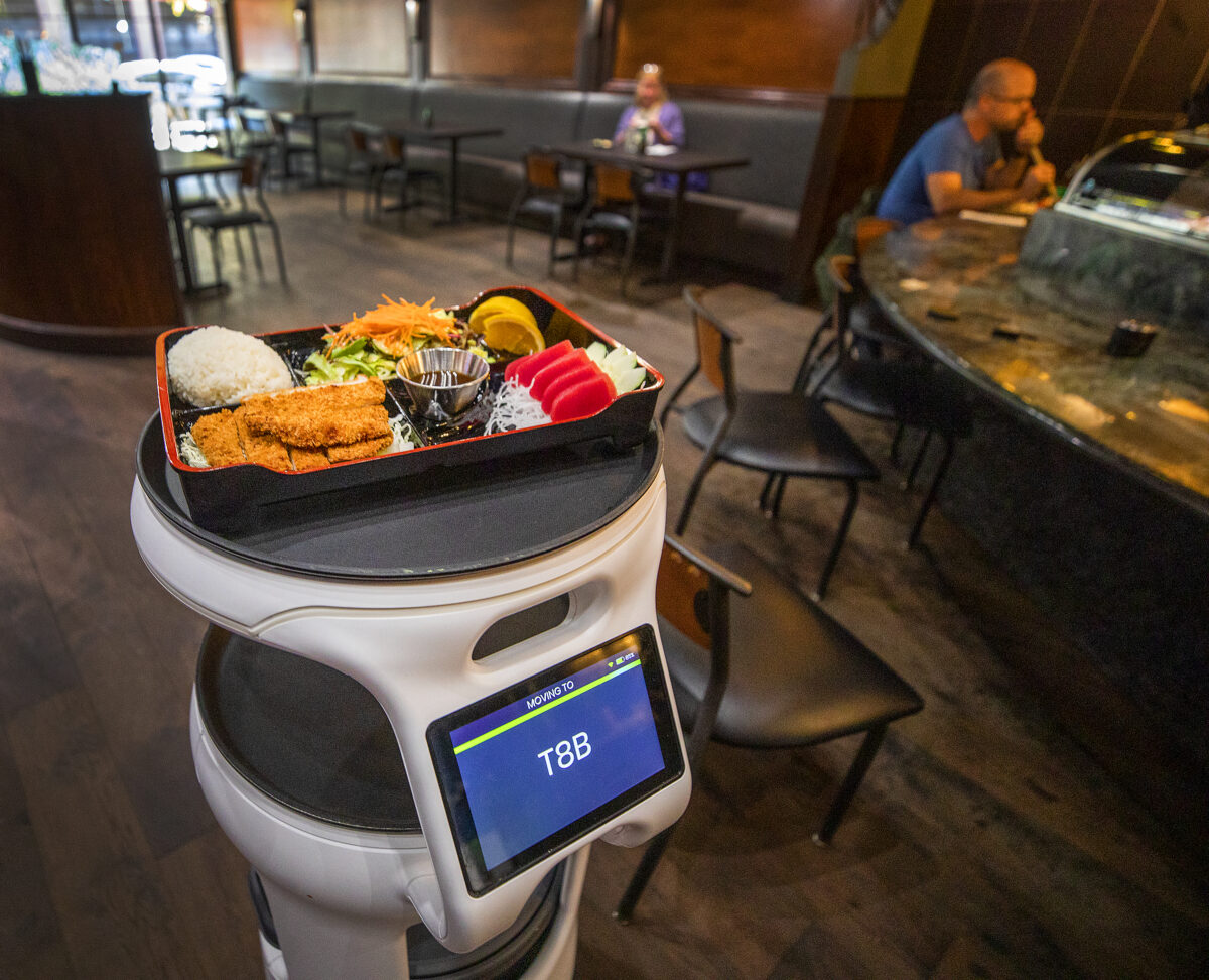 A robot brings a bento box lunch to a diner at Sushi Rosa in downtown Santa Rosa in 2021. Robots in restaurants are just one form of artificial intelligence showing up in cooking and dining. (Mariah Hanson)