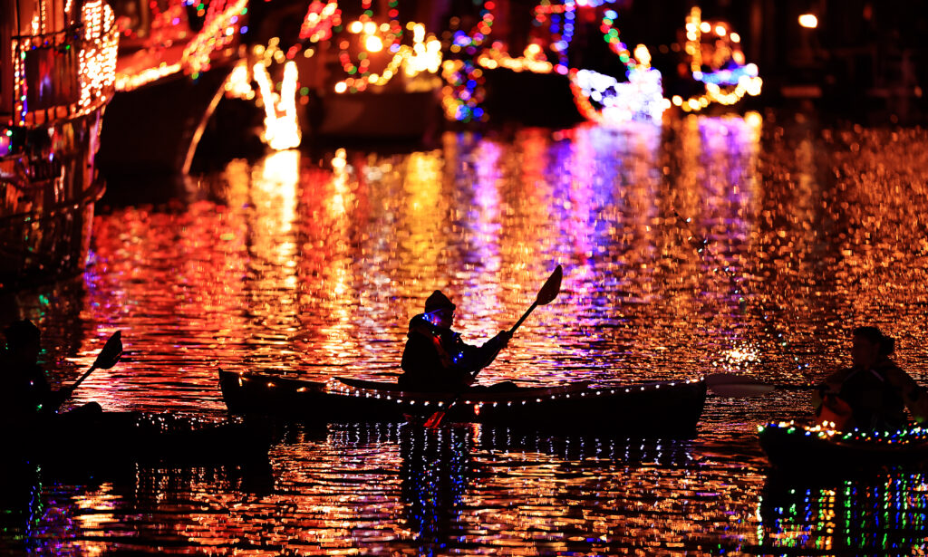 Kayakers navigate the Petaluma turning basin during Petaluma's lighted boat parade, Saturday, Dec. 11, 2021. (Kent Porter / The Press Democrat) 