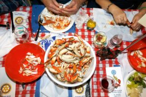 Guests dig into a feast of crab and all the fixings during the 31st annual Russian River Rotary Crab Feed at Shone Farm, in Santa Rosa. (Alvin Jornada / The Press Democrat)