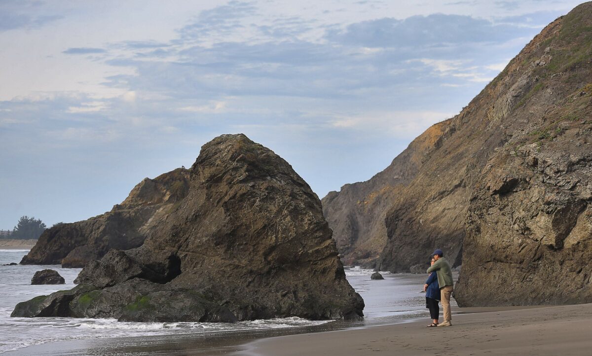 Aimi and Leon Gallego, of San Jose, enjoy the view from the beach, near the Pinnacle Gulch Coastal Access Trail, south of Bodega Bay. (Christopher Chung/The Press Democrat)