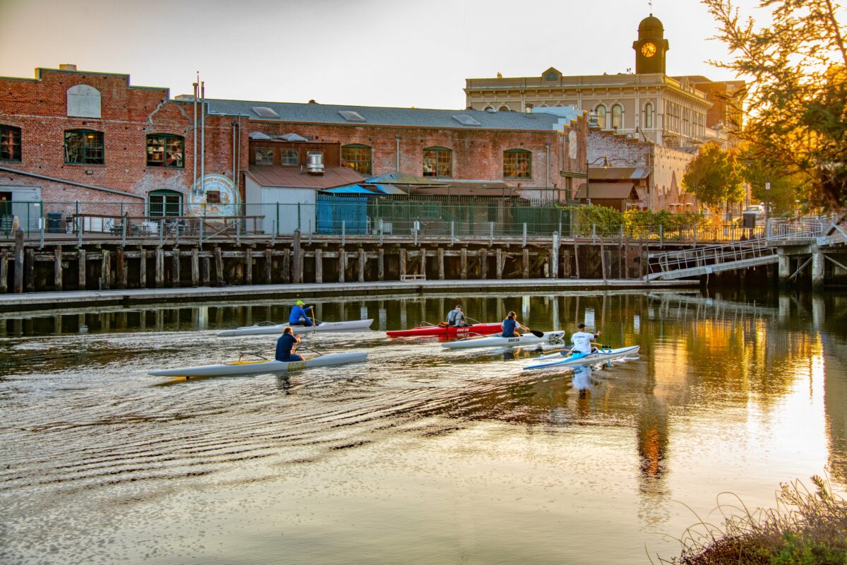 People kayak down the river in downtown Petaluma. (Sonoma County Tourism)