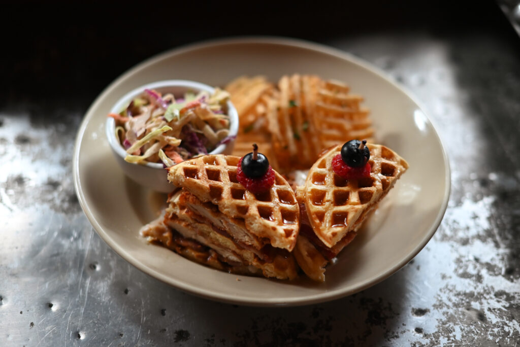 Chicken and waffle stack at Agriculture Public House at Dawn Ranch in Guerneville, Calif. on Saturday, Dec. 24, 2022. (Erik Castro / For The Press Democrat)