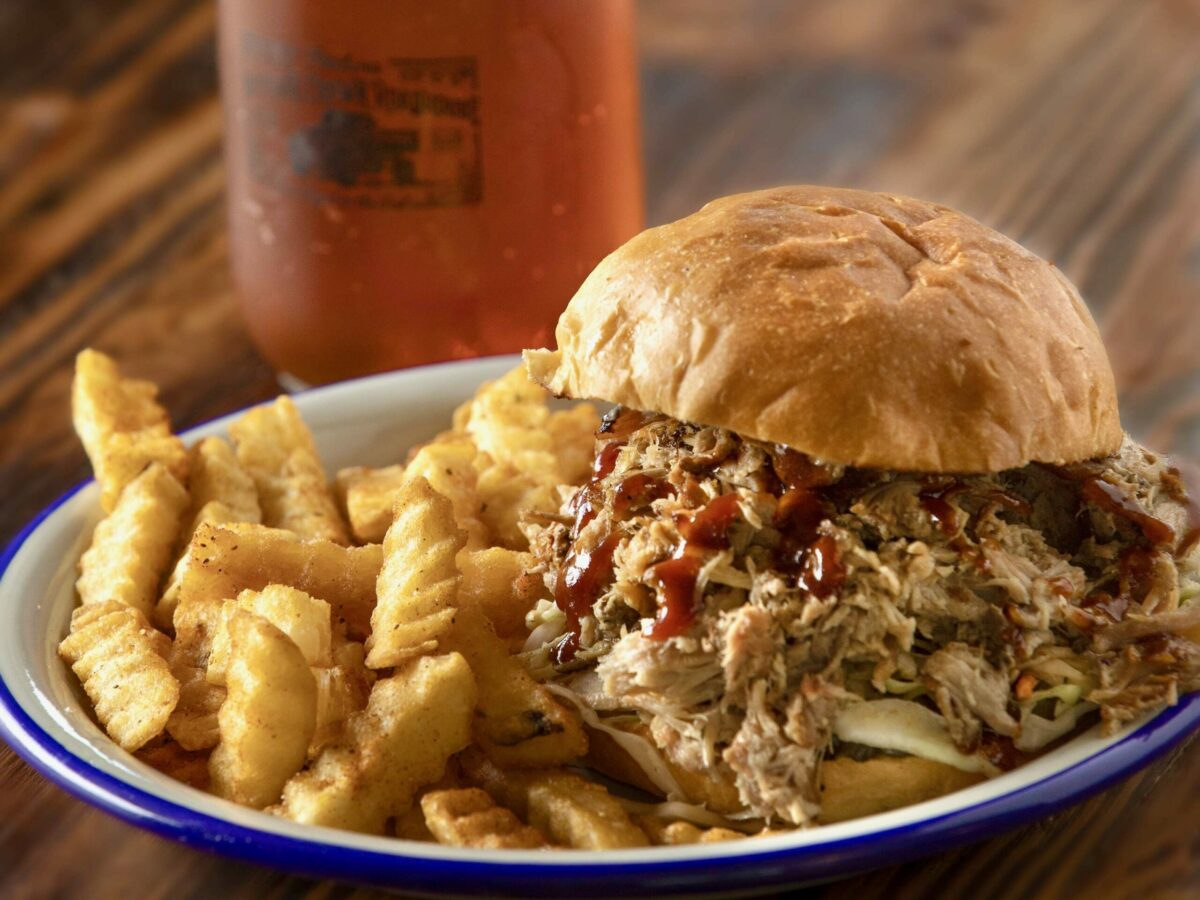 The Big Paps served with smoked Cuban mojo pork shoulder, Caribbean coleslaw, pickles, chipotle BBQ drizzle from the Butcher Crown Roadhouse in Petaluma. (John Burgess/The Press Democrat)