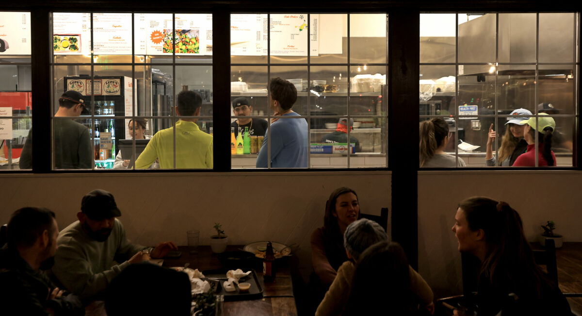 After finishing an evening run, participants of Healdsburg Running Co's run, order food at Lepe's Taqueria in Santa Rosa, Thursday, Feb. 9, 2023. (Kent Porter / The Press Democrat) 2023