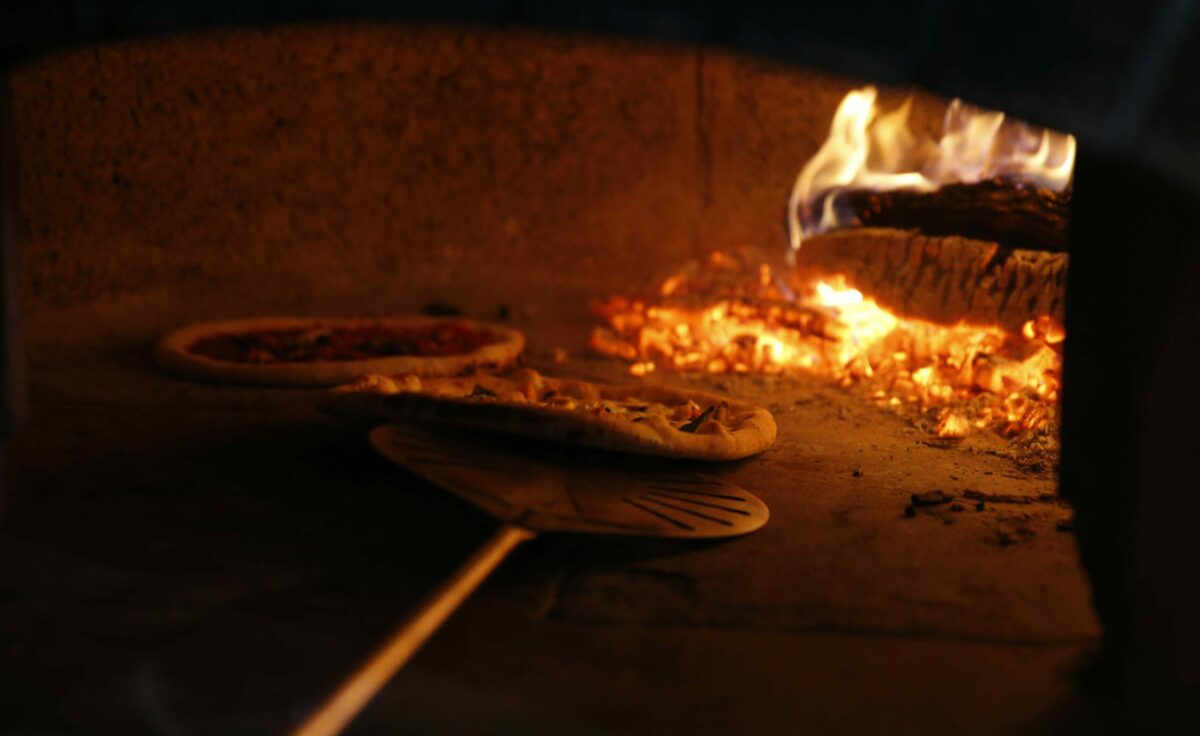 Dino Bugica of Diavola Pizzeria puts a pizza into the oven during the RISE UP SONOMA culinary event at Sonoma Country Day School in Santa Rosa on Sunday, December 3, 2017. (BETH SCHLANKER/Press Democrat)