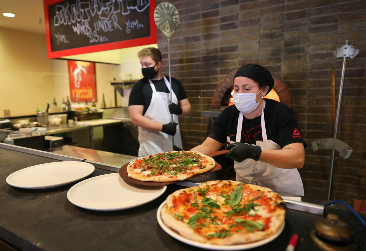 Ana Diaz prepares pizzas for customers at Rosso Pizzeria in Santa Rosa on Monday, February 22, 2021. (Christopher Chung/ The Press Democrat)