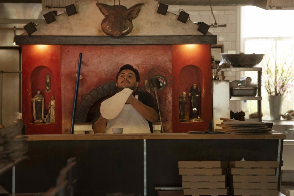 Pedro Bensin making wood-fired pizzas in an empty dining room at Diavola Pizzeria & Salumeria in Geyserville, California on April 3, 2020. (Erik Castro/for Sonoma Magazine)