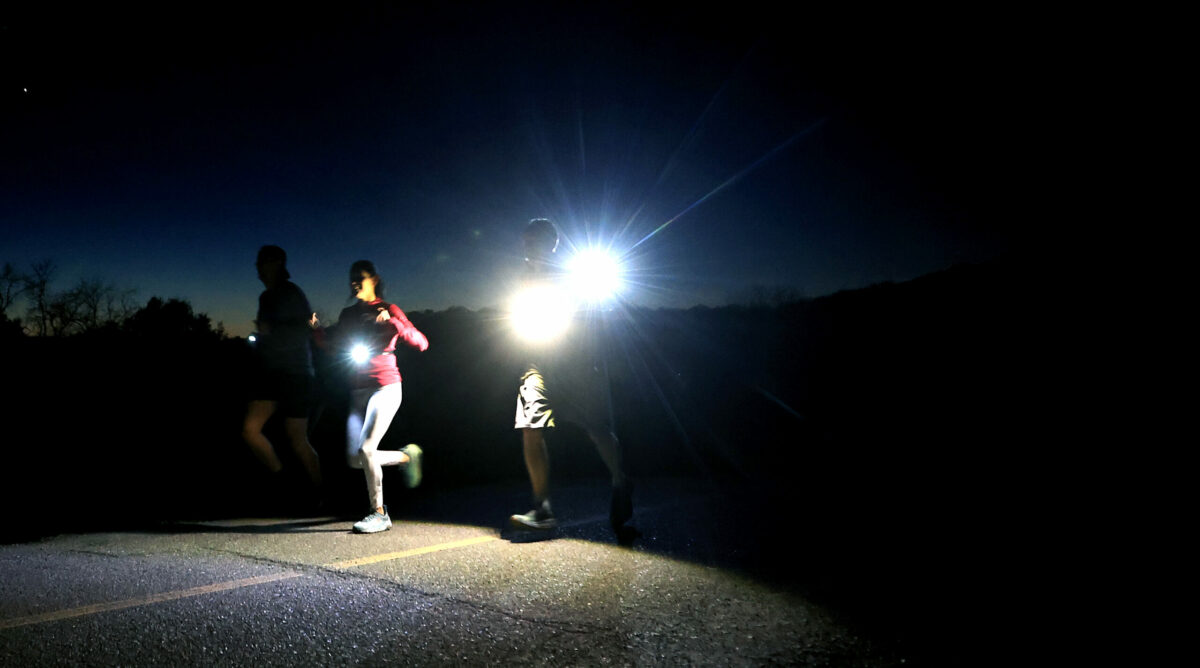 Runners make it across the Spring Lake dam during Healdsburg Running Co's run and a meal afterward, at Lepe's Taqueria in Santa Rosa, Thursday, Feb. 9, 2023. (Kent Porter / The Press Democrat) 2023