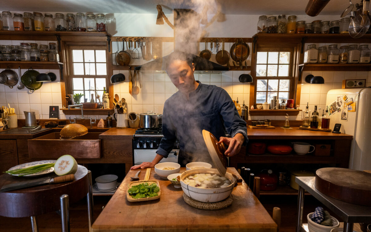 After adding the cooked noodles to the bowl, chef Adrian Chang ladles the soup and adds sesame oil, green onions, and greens to his Lo Fong Tong with pork ribs and winter melon in his west county kitchen. (John Burgess/Sonoma Magazine)