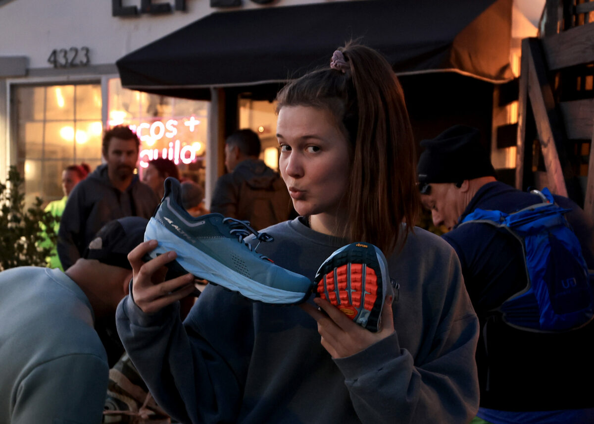 Sadie Alloway from Sebastopol displays a new shoe she picked out at Healdsburg Running Co's run and a meal afterward, at Lepe's Taqueria in Santa Rosa, Thursday, Feb. 9, 2023. (Kent Porter / The Press Democrat) 2023