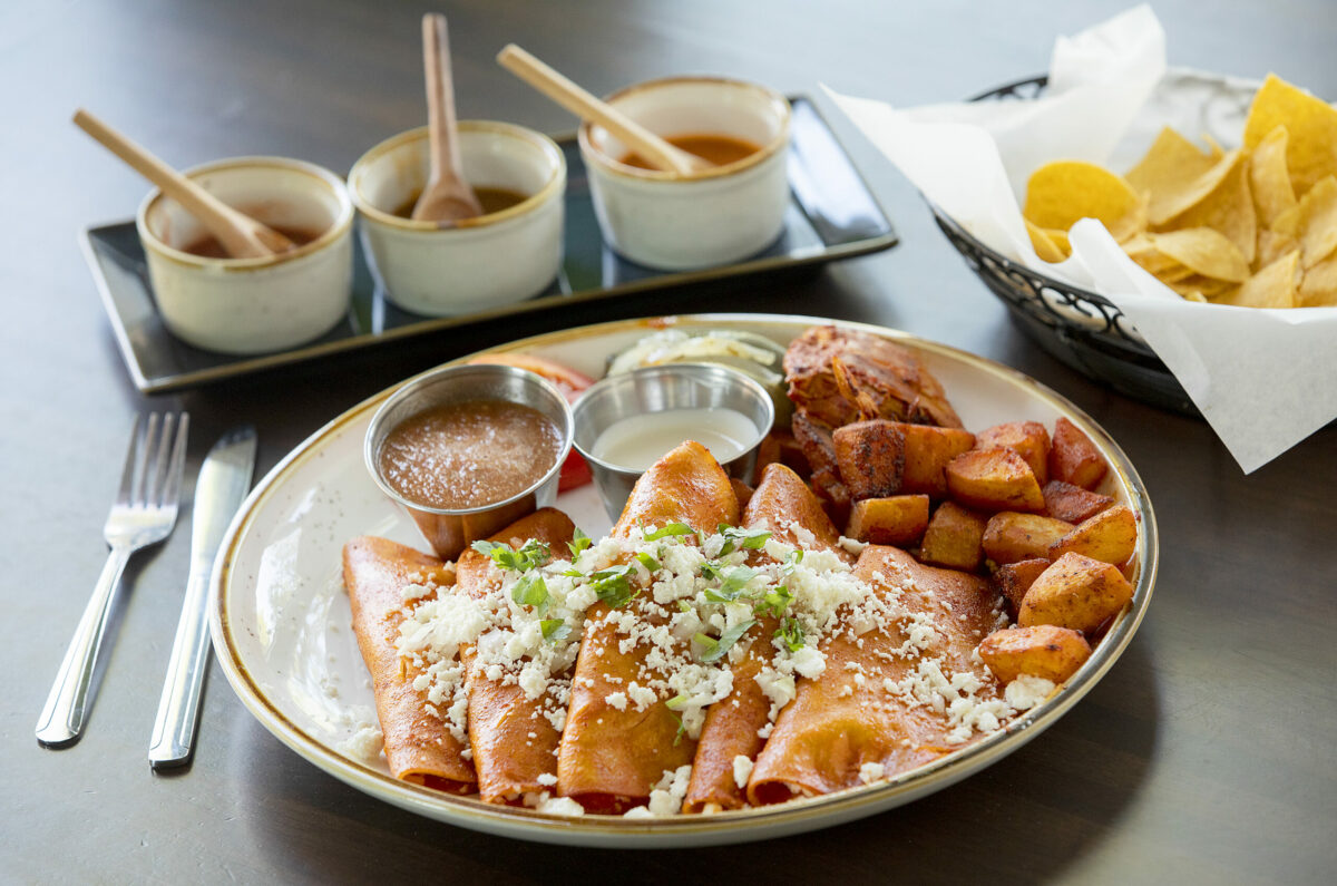 Enchiladas Michoacan includes five enchiladas filled with quest fresco covered in guajillo sauce with potatoes and marinated chicken from Cielito Lindo restaurant in Santa Rosa. (John Burgess/The Press Democrat)