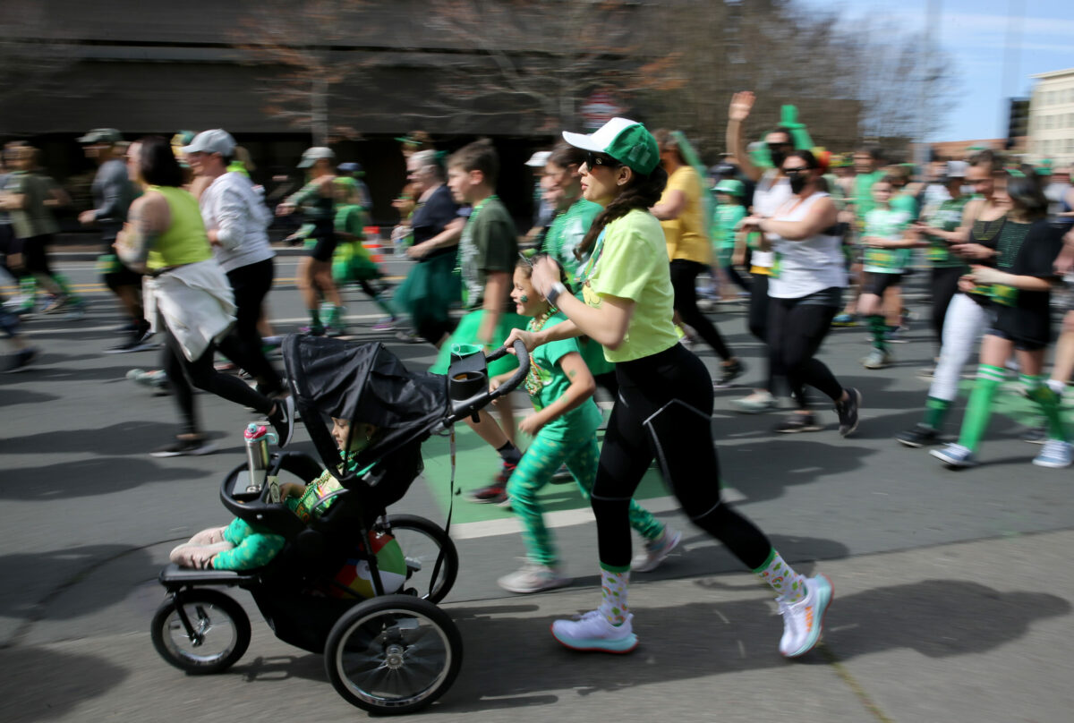Jessica Bailon Jimenez runs with her daughters Daleysa Garcia, 8, and Ariadne Garcia, 6, during the St. Patrick's Day 5K on Santa Rosa Ave. near Old Courthouse Square in Santa Rosa, Calif., on Sunday, March 13, 2022. (Beth Schlanker/The Press Democrat)