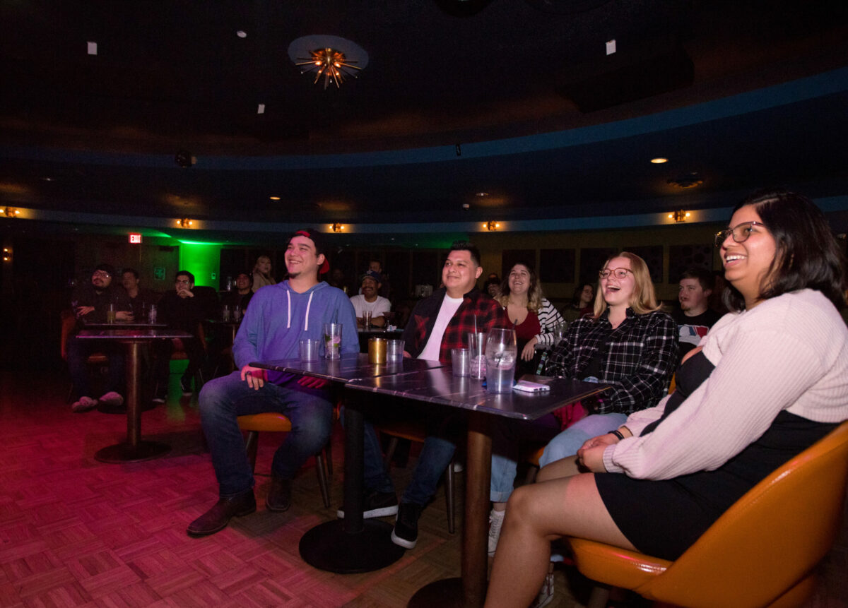 Seated at the front table, from left, Drew Kiesel, of Santa Rosa, Martin Castaneda, of Santa Rosa, Ary Rowley, of Rohnert Park, and Yohanna Ramirez, of Santa Rosa, laugh while watching the Don't Tell Comedy show at the Flamingo Resort, Thursday, February 9, 2023, in Santa Rosa. (Darryl Bush / For The Press Democrat)