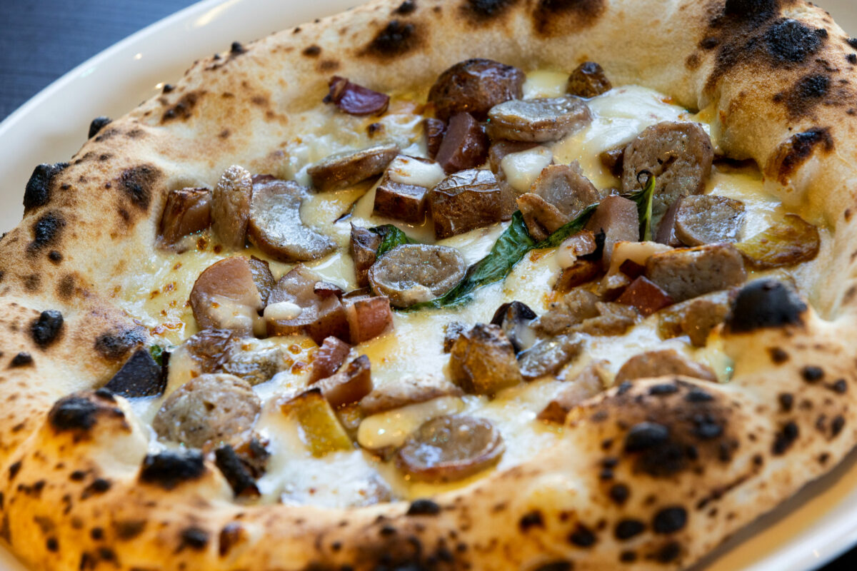 Pizza Rustica with Parmigiano cream sauce, topped with roasted potatoes, smoked provolone, Italian sausage and EVO from L'oro di Napoli in downtown Santa Rosa March 24, 2023. (John Burgess/The Press Democrat)