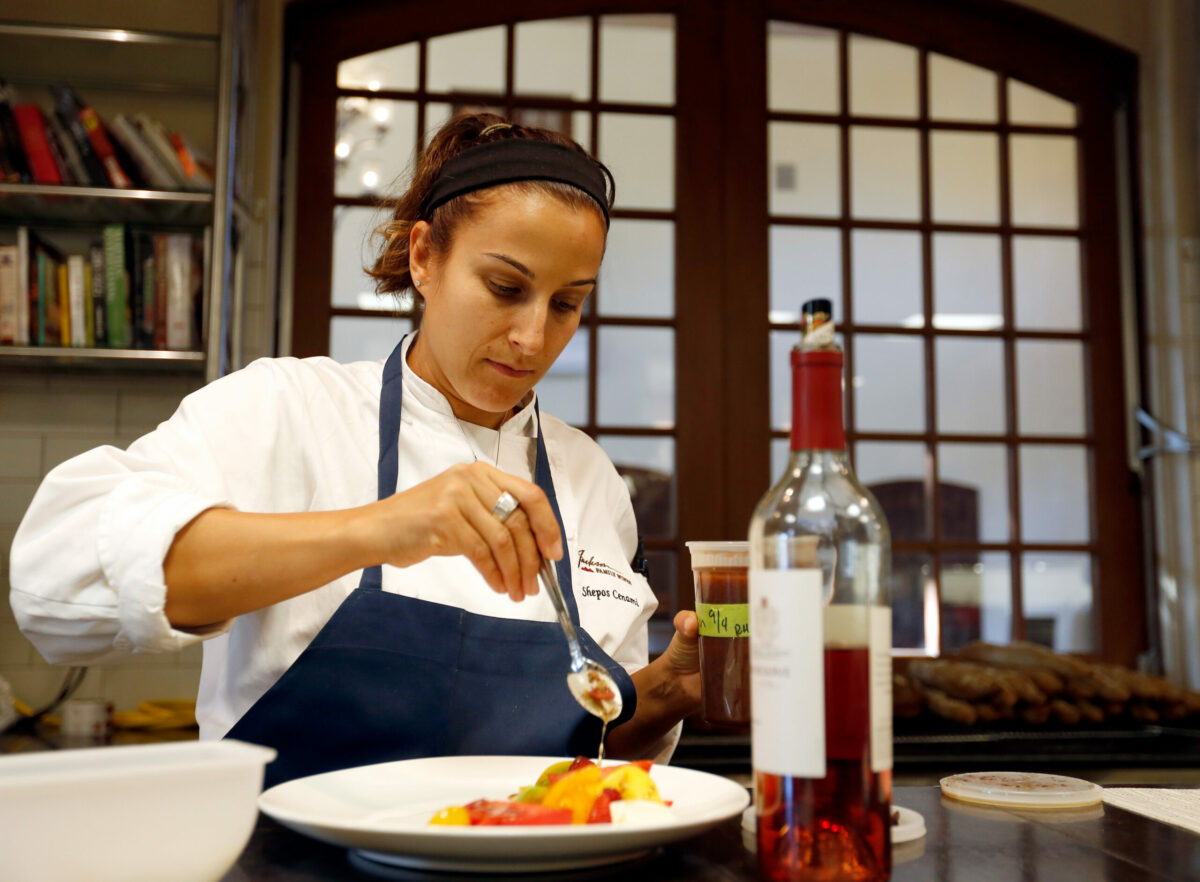 Chef Tracey Shepos Cenami drizzles ume plum vinaigrette onto an heirloom tomato salad at Kendall-Jackson Wine Estate and Gardens in Santa Rosa. (Alvin Jornada / The Press Democrat)