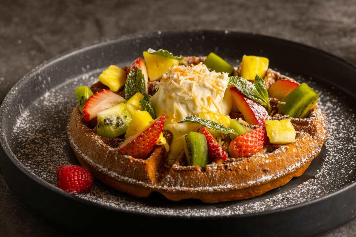 The Aloha Waffle with orange-vanilla butter, fresh berries, whipped cream and toasted coconut from the Lazeaway Club at the Flamingo Hotel in Santa Rosa Tuesday, March 28, 2023. (John Burgess/The Press Democrat)