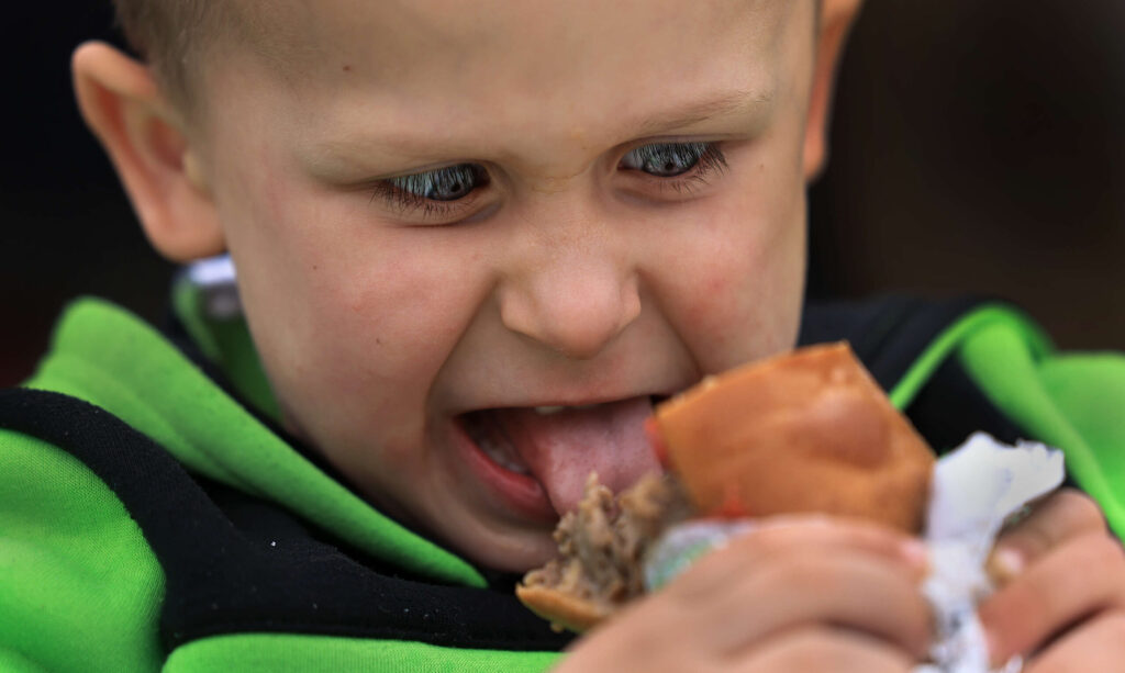 Four year-old Henry Vedder prepares to bite in to a cheesesteak sandwich during the 2nd Annual Cheesesteak Festival at Parliament Brewing Company in Rohnert Park, Saturday, March 22, 2025. (Kent Porter / The Press Democrat)