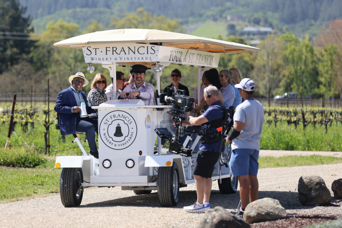 NBC's "Today" show co-host Al Roker, left, rides on a wine tasting trolley during a taping of the show at St. Francis Winery in Santa Rosa, Thursday, April 20, 2023. (Beth Schlanker / The Press Democrat)