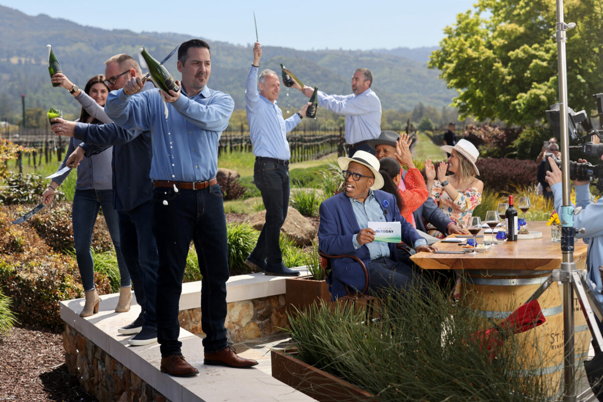 NBC's "Today" show third-hour co-host Al Roker, center, reacts as St. Francis Winery employees open bottles of sparking wine with sabers during a taping for the morning show's third-hour opening segment at St. Francis Winery in Santa Rosa, Thursday, April 20, 2023. (Beth Schlanker / The Press Democrat)