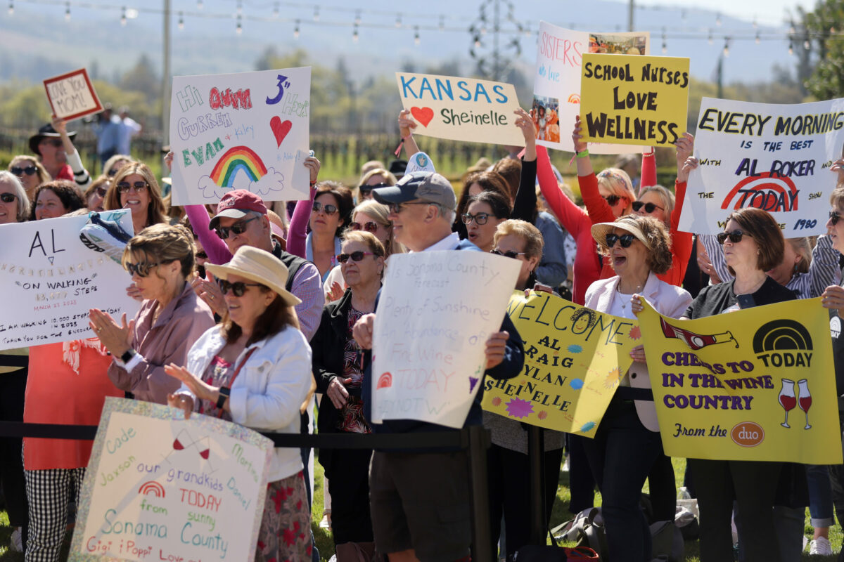 Fans hold up signs during a taping of NBC's "Today" show at St. Francis Winery in Santa Rosa, Thursday, April 20, 2023. (Beth Schlanker / The Press Democrat)