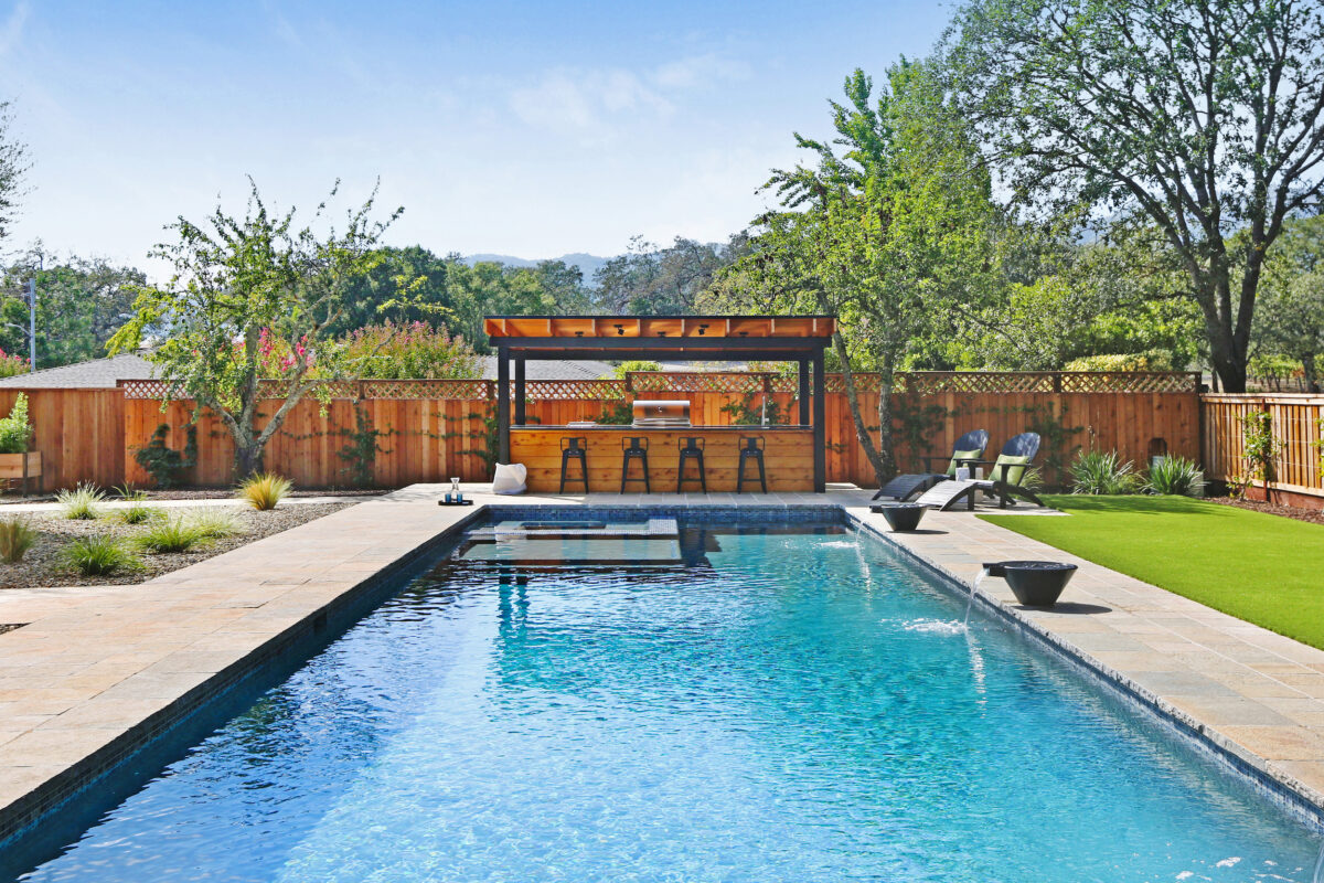 An outdoor kitchen is connected to the design via the same Alaskan cedar and a black steel trim. (Rick Bolen Photography)