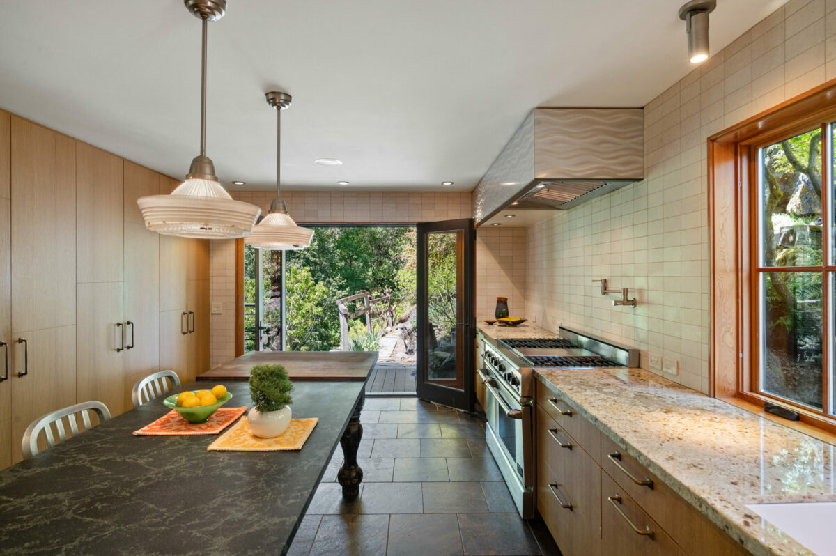 The kitchen has granite countertops, slate tile and a hand carved aluminum hood. (Lunghi Studios)