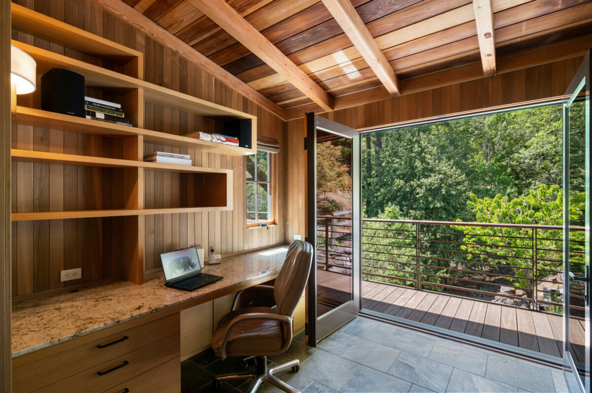 Large doors bring the outside in to this office with plenty of built-in cabinetry. (Lunghi Studios)