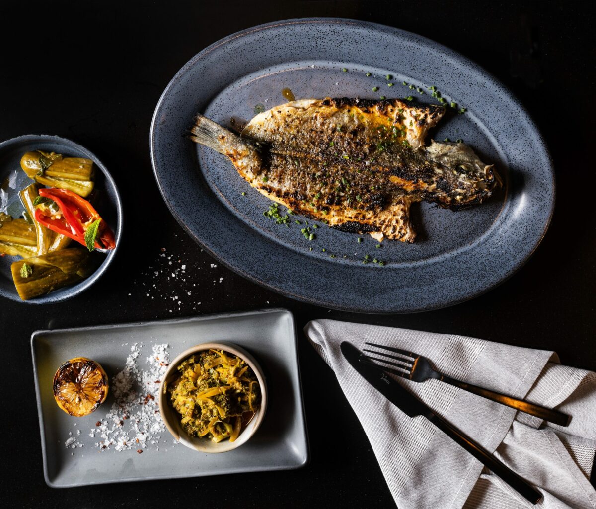 Whole Grilled Bronzino with a side of Broccoli Tabbouleh and homemade pickles from Goldfinch restaurant Wednesday, May 24, 2023, in Sebastopol. (John Burgess/The Press Democrat)