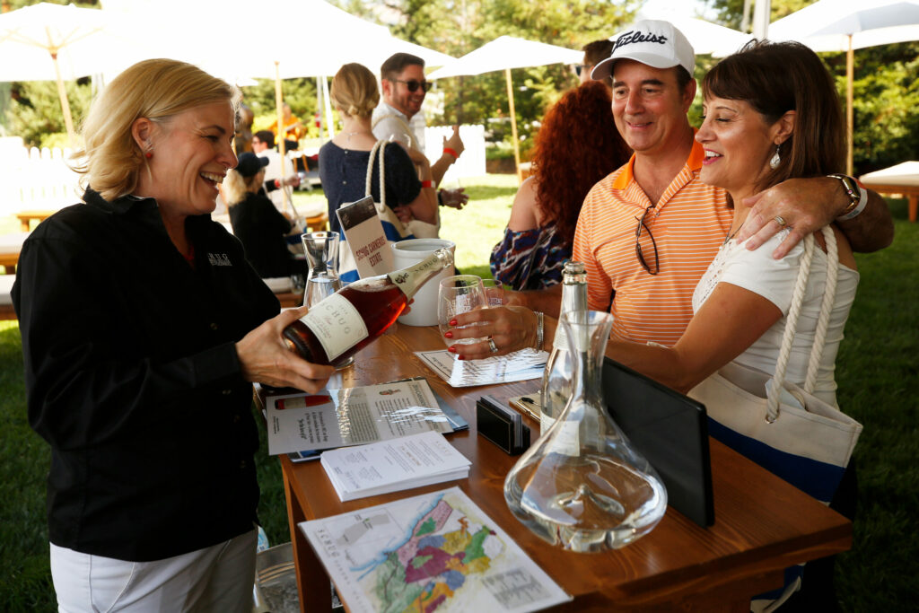 Claudia Schug, left, of Schug Winery pours tastes of Rouge de Noir sparkling pinot noir brut for John and Parveen Dennis of Windsor during Taste of Sonoma at the Sonoma State University's Green Music Center, in Rohnert Park, California, on Saturday, August 31, 2019. (Alvin Jornada / The Press Democrat)