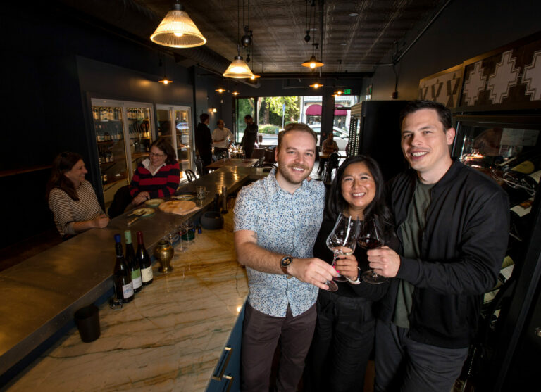 Co-owners from left, Ryan Knowles, Jade Hufford, and Evan Hufford, toast together inside Maison Wine Bar in Healdsburg, Friday, June 23, 2023. (Darryl Bush / For The Press Democrat)