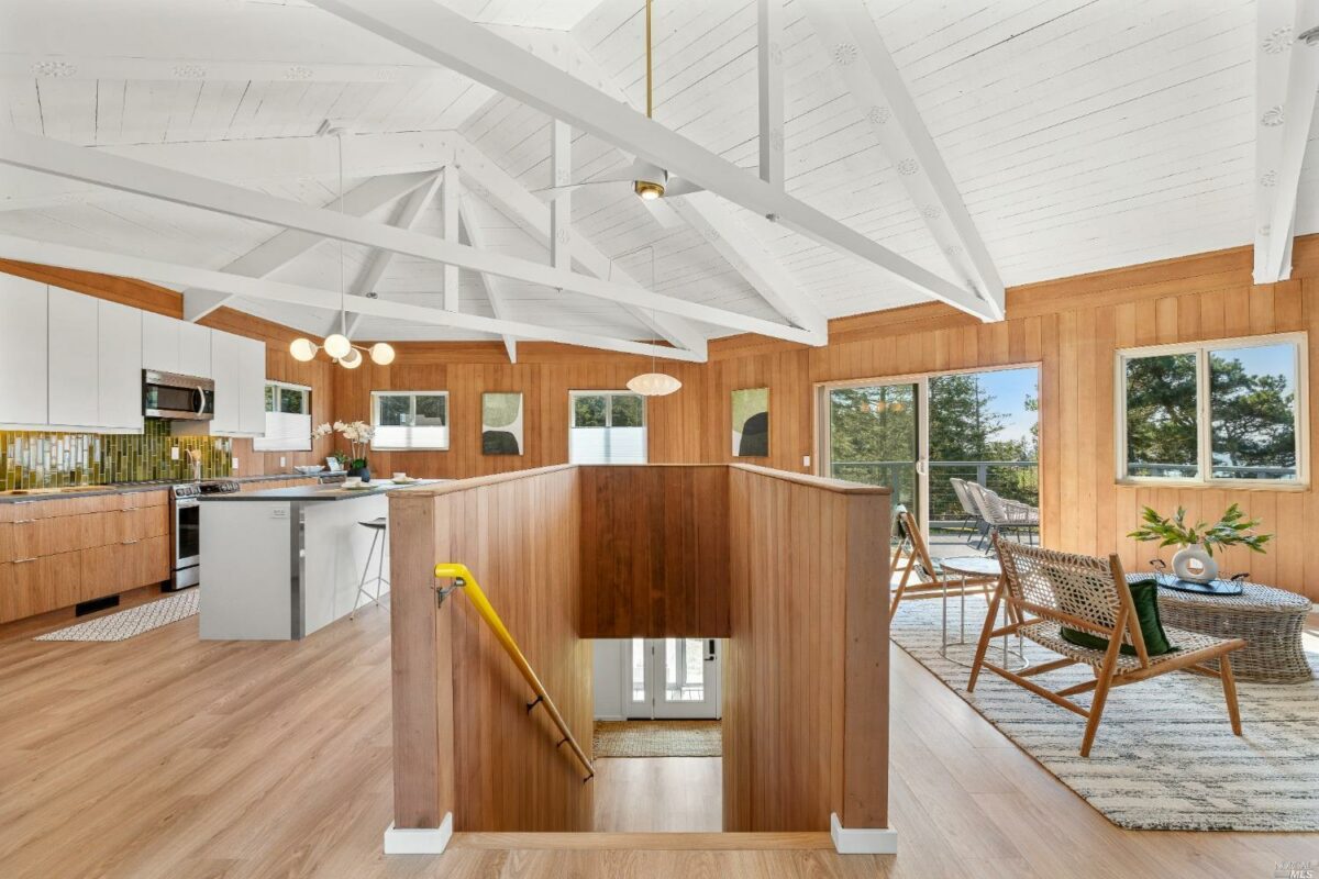 A bright yellow staircase handrail is a nod to the design work of Sea Ranch founding architect Donlyn Lyndon. (Bill Oxford Photography)