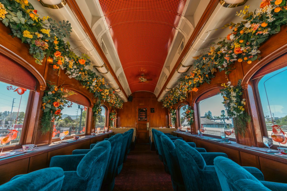 An afternoon tea service experience in a vintage railcar draped in synthetic spring-inspired flowers aboard the Napa Valley Wine Train. (Napa Valley Wine Train)