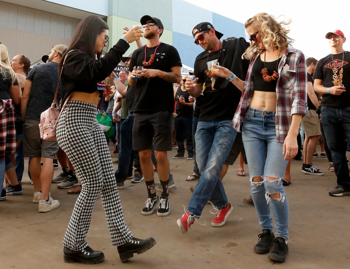 Alanah Cole, left, Colton Ryals, Evan Maurer, and Christa Sager dance together while the band Gentlemen Soldiers performs on stage during HenHouse Brewing Company's Freshtival beer festival at SOMO Village Event Center in Rohnert Park on Saturday, October 12, 2019. (Alvin Jornada / The Press Democrat)