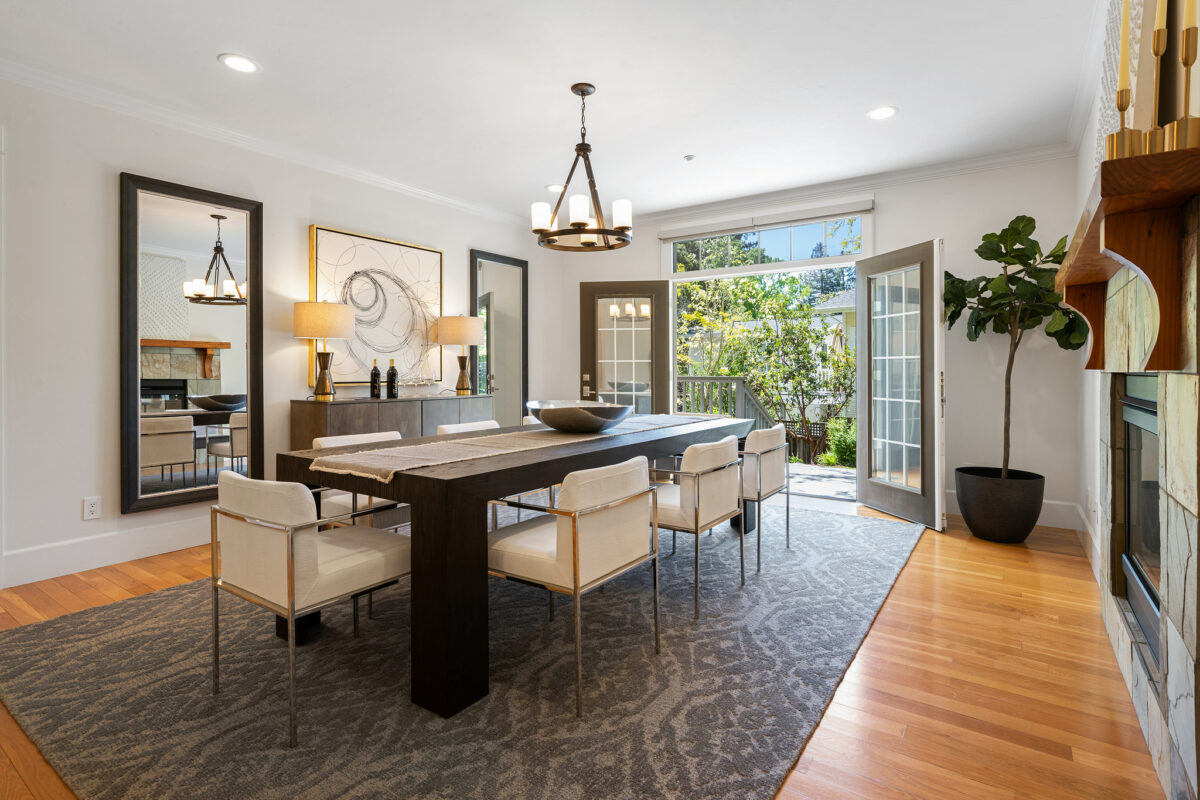 The dining room shares the fireplace with the living room and also connects to the kitchen and yard. (Open Homes Photography)