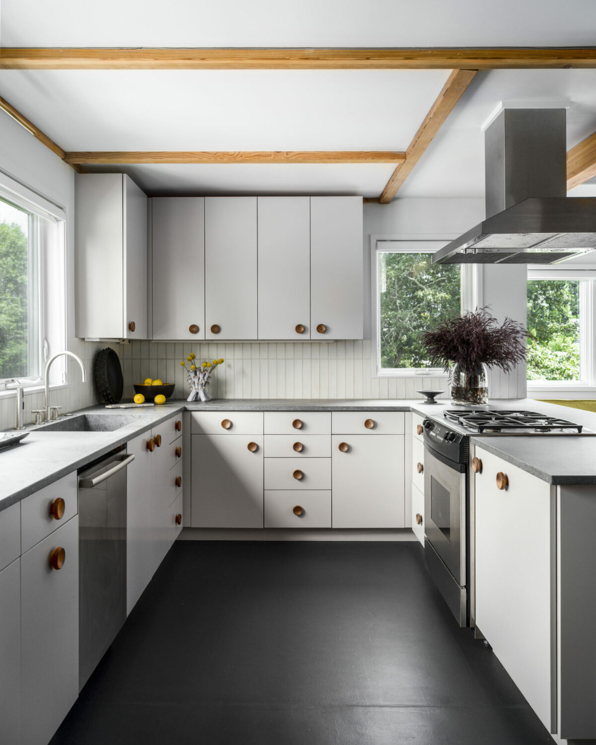 Oversized walnut knobs on cabinets throughout the home provide playful albeit subtle contrast. (Christopher Stark)