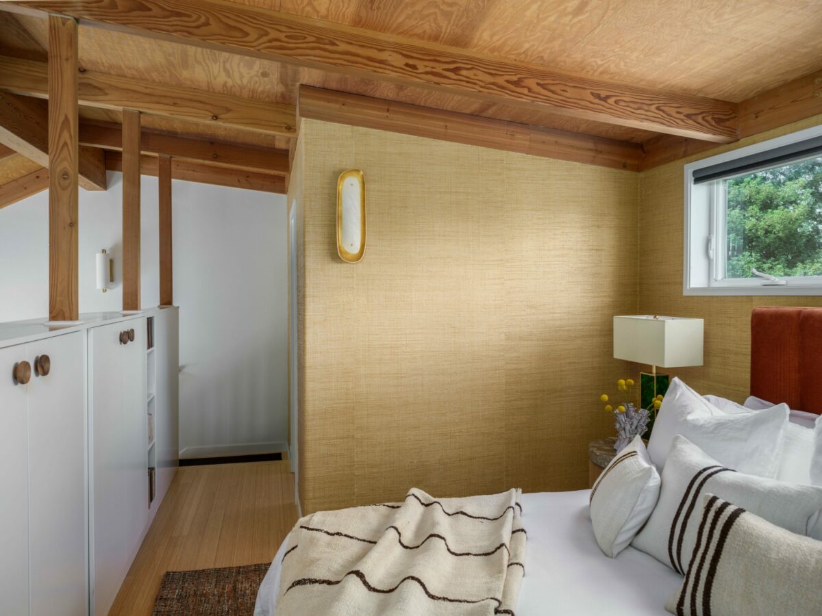 An organically-shaped sconce, wheat raffia wallpaper and other exquisite details in the bedroom. (Christopher Stark)