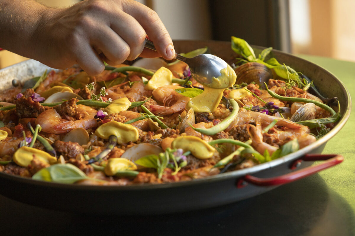 Chef Perry Hoffman adds a dash of saffron aioli to his paella at Boonville Hotel's onsite restaurant. (John Burgess/The Press Democrat)