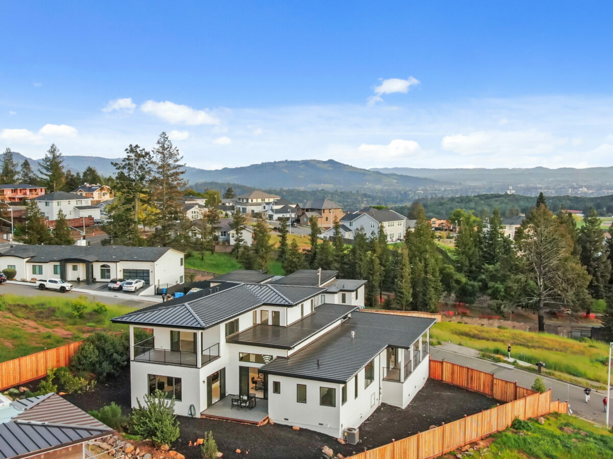 The white exterior is sharply contrasted with a black metal roof. (Lunghi Studio)