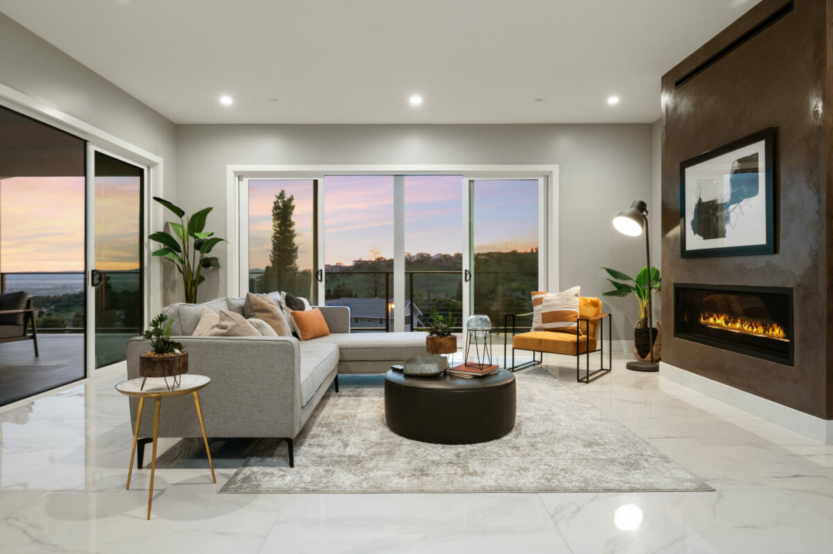 A plaster fireplace is a showstopping focal point, however rivaled by spectacular views. (Lunghi Studios)