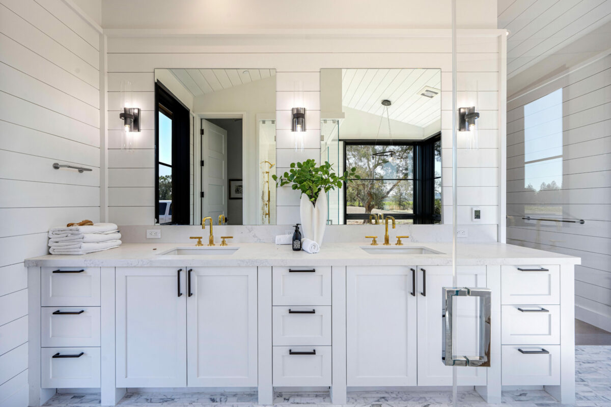 Mixed metals–brass, iron and nickel—accent the bathroom vanity. (Robert Vente / Sotheby’s International Realty)