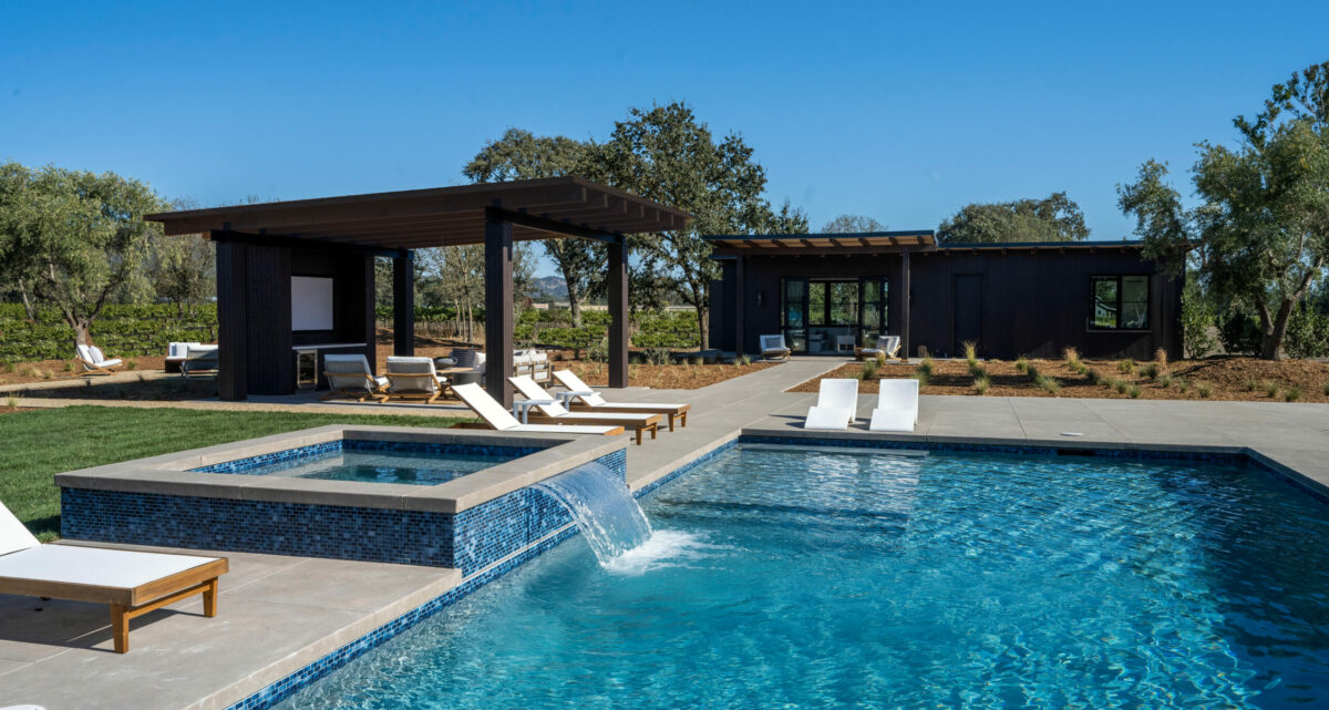 The swimming pool, a guesthouse and a covered lounging area with a movie screen. (Robert Vente / Sotheby's International Realty)
