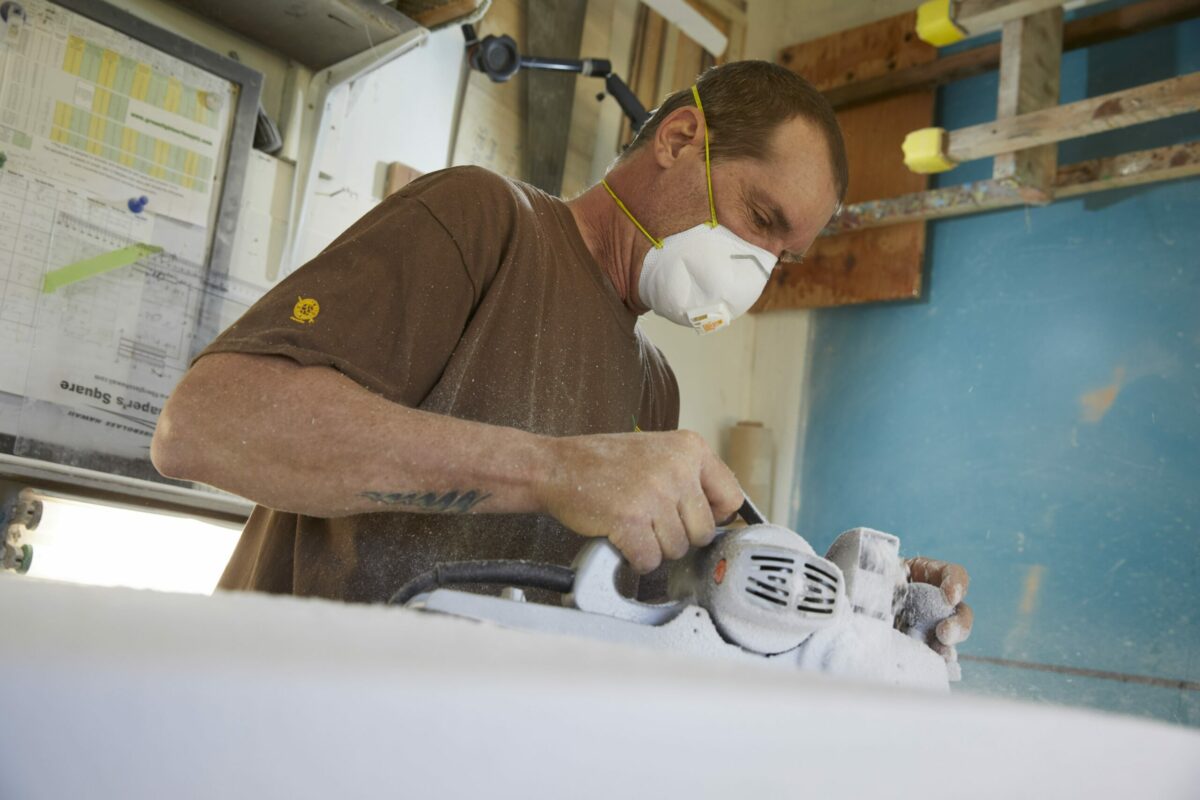 In his home studio in rual Sebastopol, Beal works a polyurethane blank into initial shape using a hand planer. (Rob Brodman)