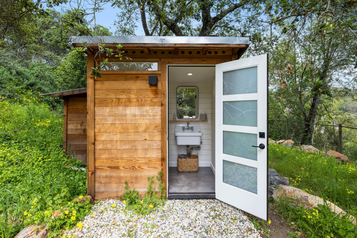 A poolside changing room includes a half-bathroom. (Open Homes Photography)