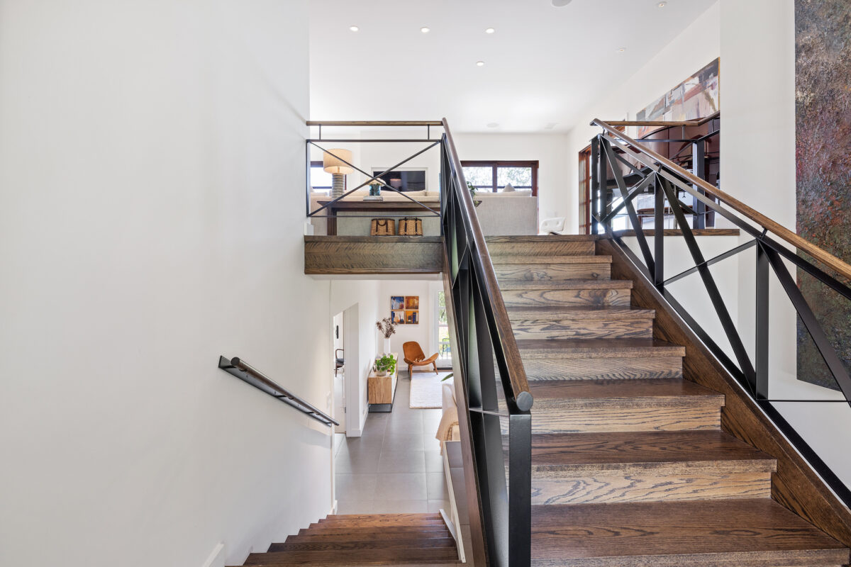 Stained wood stairs tie in well with the current home design trend that's leaning toward warmer interiors. (Open Homes Photography)