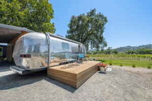 A custom-built deck provides easy access to a vintage Airstream (and more vineyard views). (Open Homes Photography)