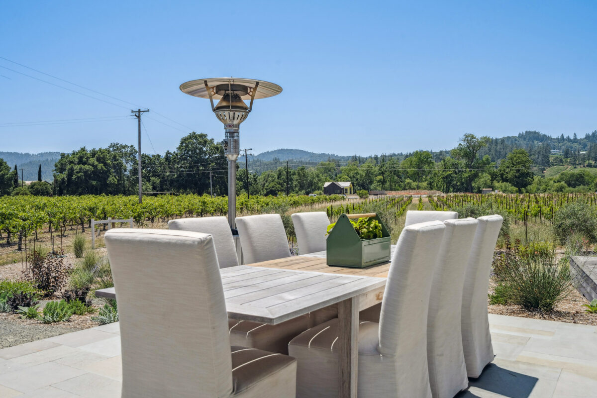 Outdoor patios allow for seating among the vines. (Open Homes Photography)