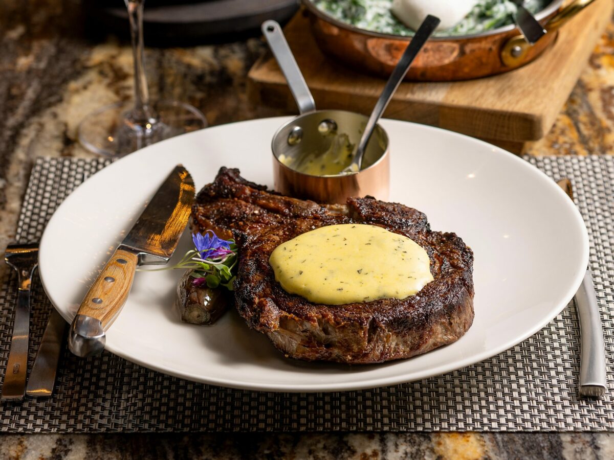 The 25 oz. Ribeye Steak with bernaise sauce, with a side of Creamed Spinach and Parker House Rolls from Goodnight’s Prime Steak + Spirits Friday, August 11, 2023 on the square in Healdsburg. (Photo John Burgess/The Press Democrat)