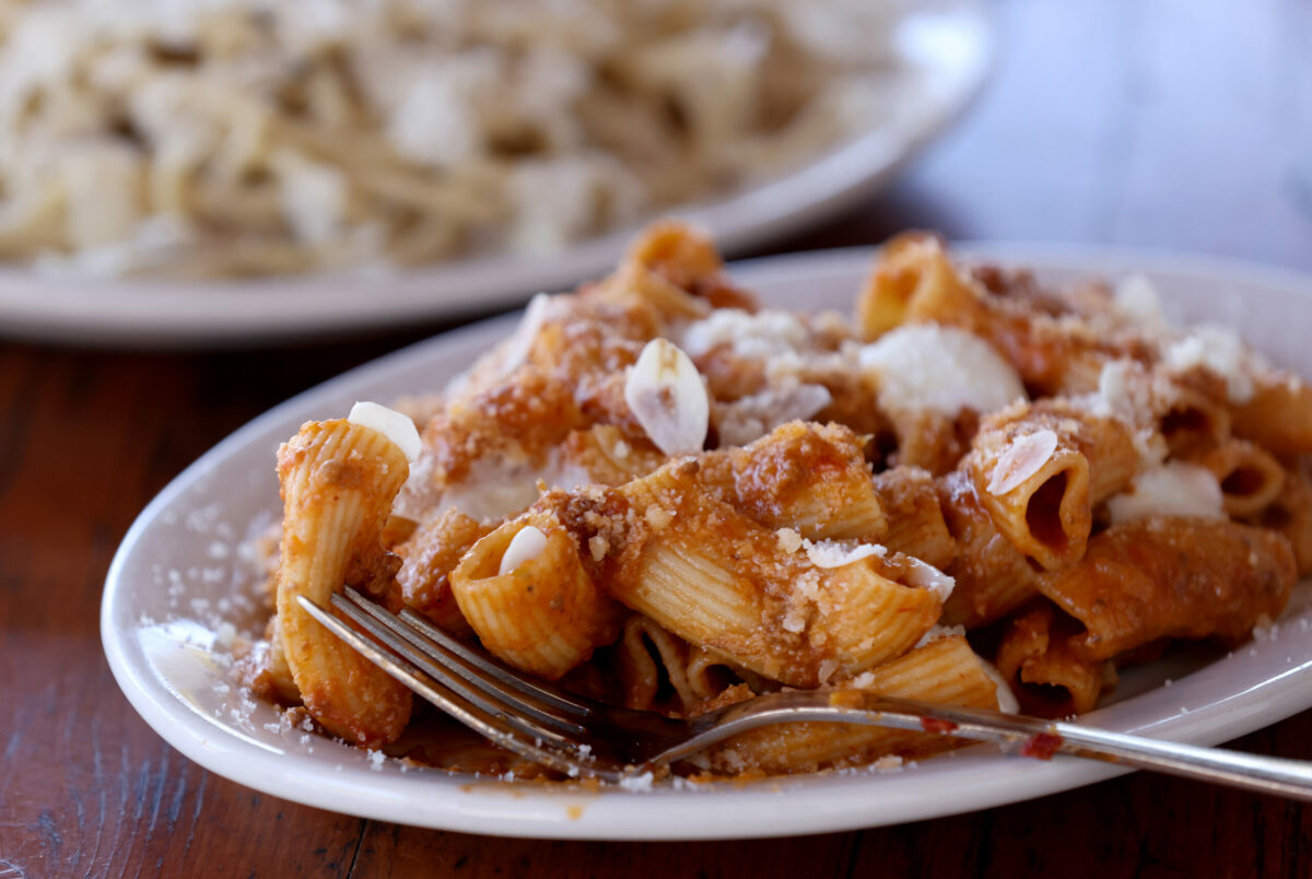Rigatoni with a beef bolognese and bechamel sauce topped with slivers of pickled garlic at Ciccio in Yountville, Monday, July 10, 2023. (Beth Schlanker / The Press Democrat)